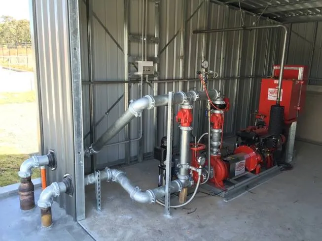 Commercial fire pump and galvanised pipework in a plant room